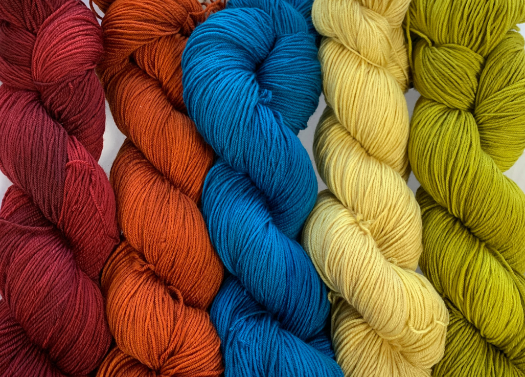 Indigodragonfly Cariboubaa hand-dyed yarn in red, orange, blue, yellow, and green