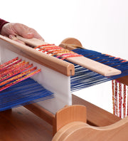 Ashford pickup stick shown in weaving on an Ashford rigid heddle loom with colorful warp