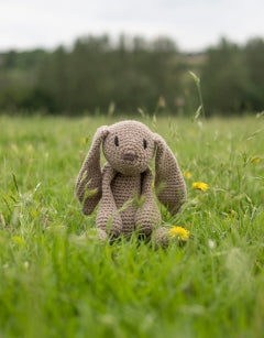 Toft crochet kit - Emma the Bunny sits in the grass